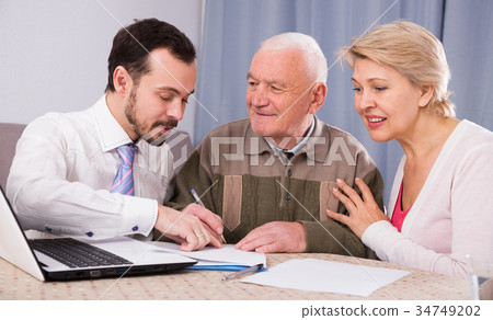 Woman and old man consider contract 34749202