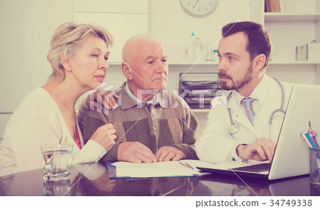 Old father with daughter visit doctor 34749338