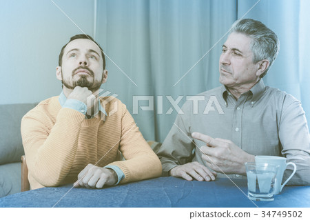 Mature father and son serious talk 34749502