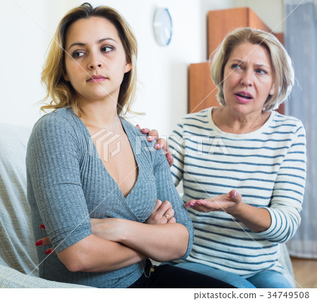Senior mother screaming on adult daughter in domestic argument Senior mother screaming on adult daughter in domestic argument 34749508