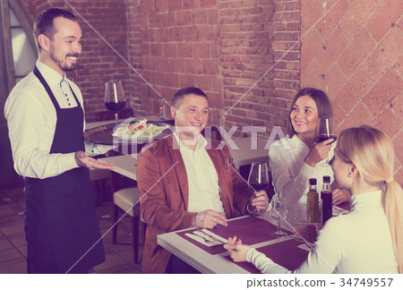 Male waiter carrying order for visitors Male waiter carrying order for visitors 34749557