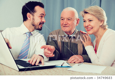 Woman and old man consider contract 34749683