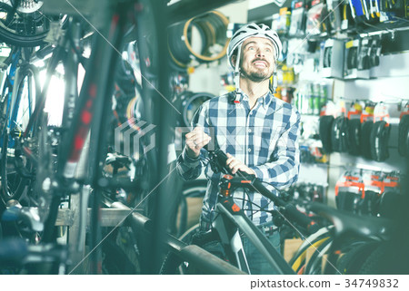 Cyclist decide on reliable bike Cyclist decide on reliable bike 34749832