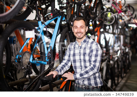 Cyclist is looking for bicycle saddles 34749839