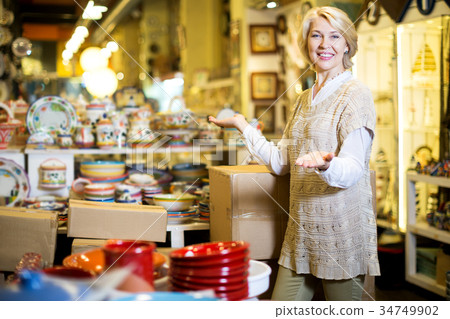 Woman posing with ceramic tableware Woman posing with ceramic tableware 34749902