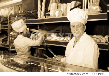 satisfied bakers with fresh bread in bakery satisfied bakers with fresh bread in bakery 34749930