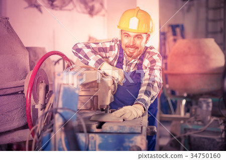Working man practicing with disk saw machine 34750160