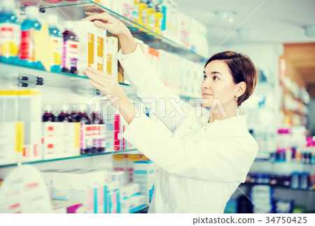 Friendly pharmacist offering reliable medicine Friendly pharmacist offering reliable medicine 34750425