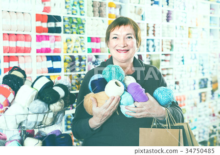 Female client is standing with shopping bags. Female client is standing with shopping bags. 34750485