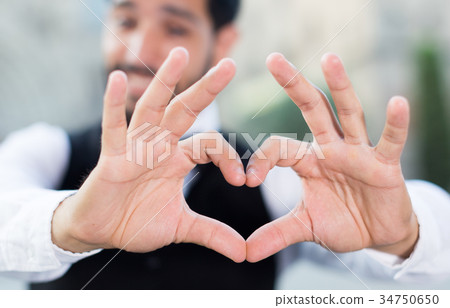 Man gesturing heart with his fingers Man gesturing heart with his fingers 34750650