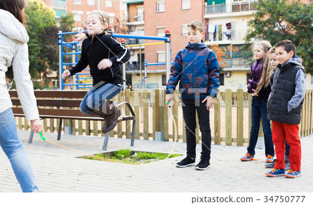 Children playing skipping rope 34750777