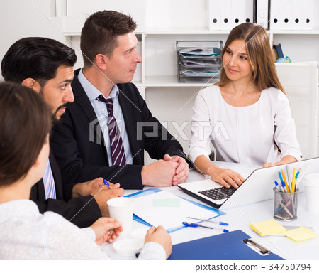 Businesswoman discussing business project with team 34750794