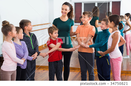 Boys and girls studying folk dance in studio Boys and girls studying folk dance in studio 34750821