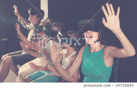 Young mother is fascinated by movie in VR glasses 34750843