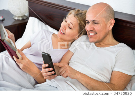 Positive happy mature couple together social networking 34750920