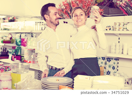 Couple selecting crockery in store Couple selecting crockery in store 34751029