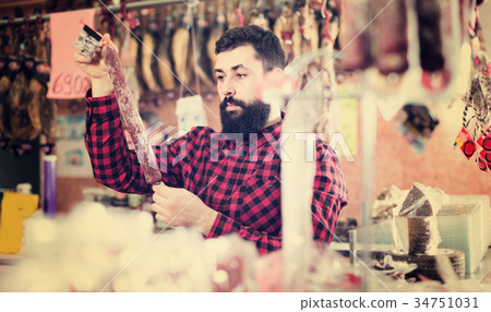 guy deciding on best sausage guy deciding on best sausage 34751031