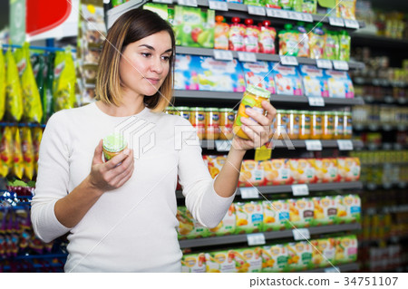 Woman choosing healthy baby food Woman choosing healthy baby food 34751107