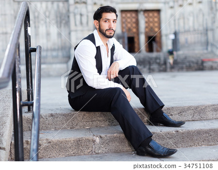 Dreaming man sitting on stone steps 34751108