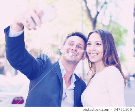Positive family couple taking selfie Positive family couple taking selfie 34751109