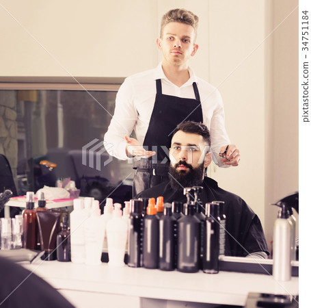 client feeling discontent about his new haircut at hair salon client feeling discontent about his new haircut at hair salon 34751184