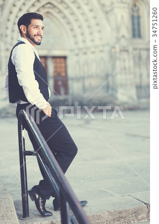 Full-length portrait of man near iron railings Full-length portrait of man near iron railings 34751260