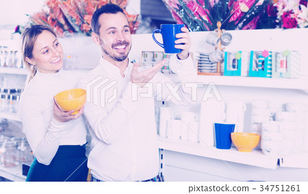 Couple selecting crockery in store 34751261