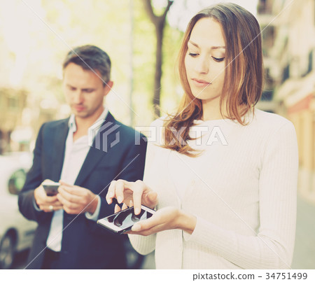 Young man and woman phubbing 34751499