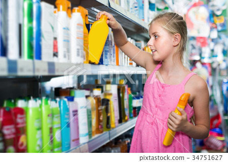Girl teenager choosing lotion of sun protection 34751627