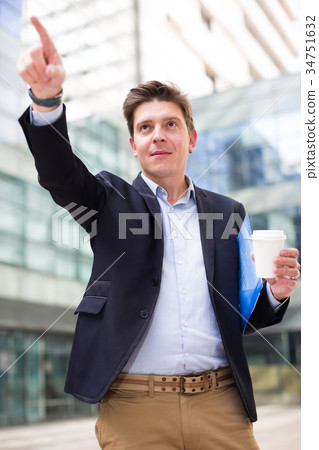 Professional man in jacket with coffee and documents Professional man in jacket with coffee and documents 34751632