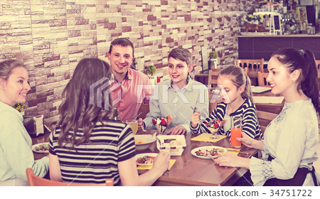 Group of adults and teenagers spending time in cafe 34751722