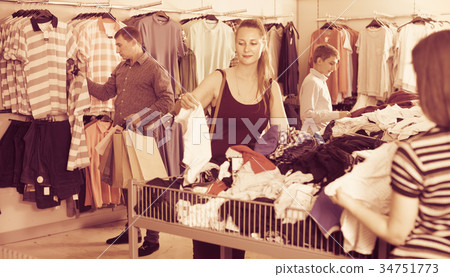 People of different ages looking clothes a half-off sale People of different ages looking clothes a half-off sale 34751773