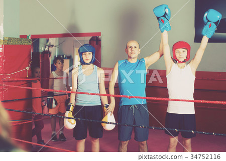 Children training on boxing ring 34752116