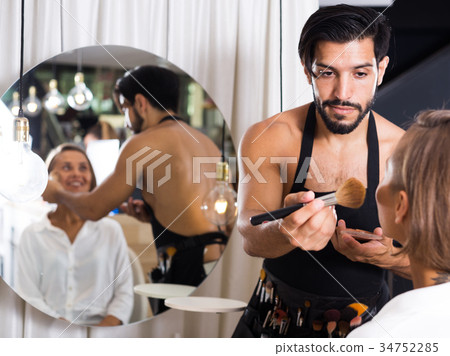 male makeup artist applying cosmetics for female male makeup artist applying cosmetics for female 34752285