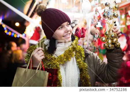 Cheerful teen girl with Christmas gifts 34752286