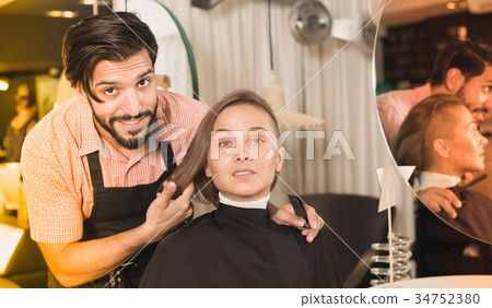professional male hairdresser with visitor 34752380