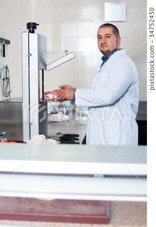 Man shop staff cutting sirloin at top Man shop staff cutting sirloin at top 34752450