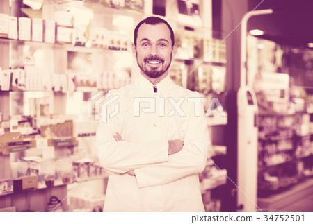 Male pharmacist demonstrating assortment of drugs Male pharmacist demonstrating assortment of drugs 34752501