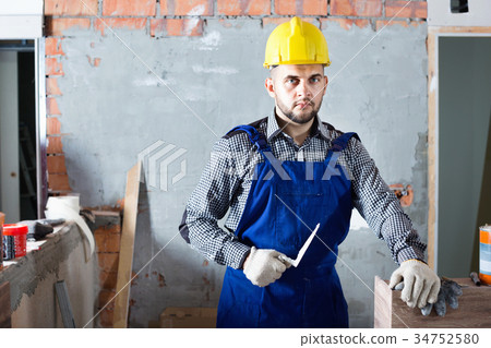 Professional plasterer is ready to plaster the walls Professional plasterer is ready to plaster the walls 34752580