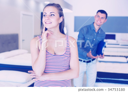Woman buying mattress Woman buying mattress 34753180