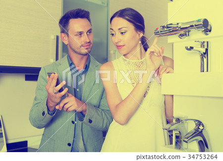 Couple choosing new mixer tap Couple choosing new mixer tap 34753264