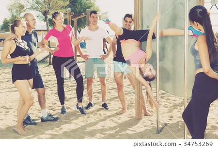 Girl performing pole exercises Girl performing pole exercises 34753269