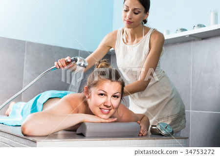 Relaxing girl enjoying beauty treatments in spa center, receiving peeling Relaxing girl enjoying beauty treatments in spa center, receiving peeling 34753272