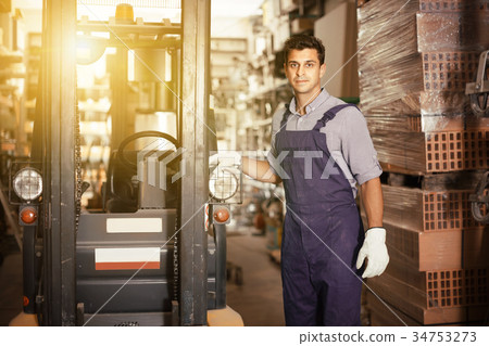 Portrait of adult sellerman in uniform in workplace 34753273