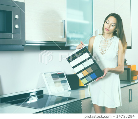 Woman choosing new kitchen tabletop Woman choosing new kitchen tabletop 34753294