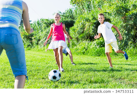 Group of laughing children playing football Group of laughing children playing football 34753311