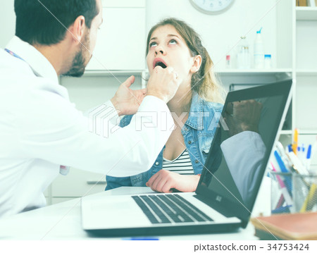 Doctor and girl with sore throat Doctor and girl with sore throat 34753424