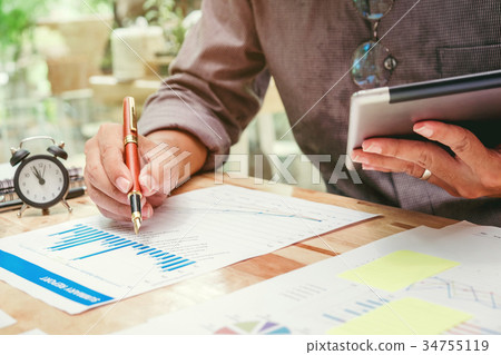 Business man Using digital tablet  Report chart  34755119