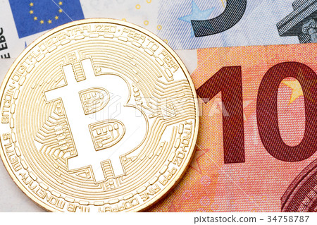 Close up of golden bitcoins on euro currency 34758787