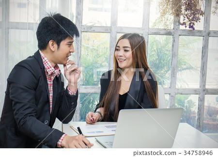 man and woman listening to colleague at meeting 34758946